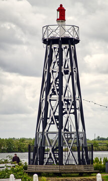 Historic lighthouse tower marking navigation for sailing boats and ships on a cloudy enkhuizen canal