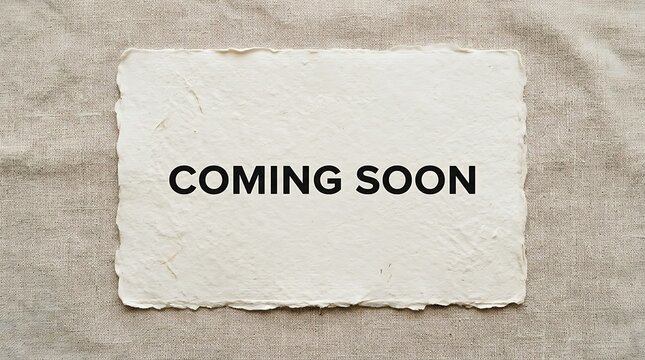 Coming soon text on a piece of textured paper