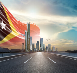 East Timor national flag wavering in beautiful clouds with building skyline. Modern Building skyline with national flag. East Timor national flag for independence day. © Muhammad Arif