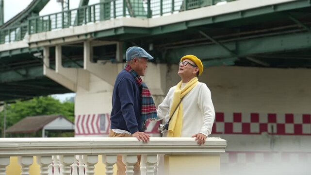 Senior LGBTQ couple enjoying conversation during a sightseeing trip in Bangkok, Thailand. Happy retirement lifestyle, travel and lasting companionship
