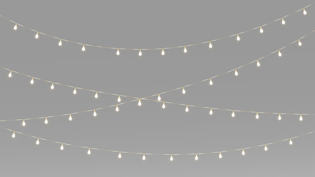 Warm Christmas string lights with crossed hanging garlands, glowing bulbs, festive illumination and elegant holiday decoration