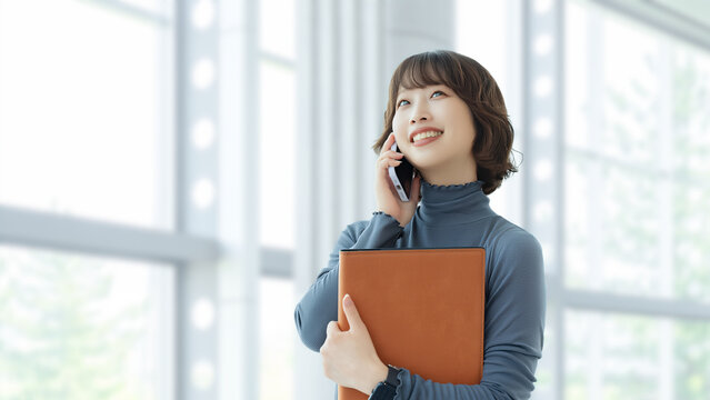 スマートフォンで話す笑顔の女性・ビジネスウーマン, Smiling Businesswoman Talking on a Smartphone