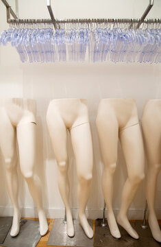 Rows of mannequins and clothes hangers, legs, storage.