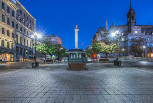 Old Montreal at dawn,a city square with a pillar and historic buildings, Nelson's Column