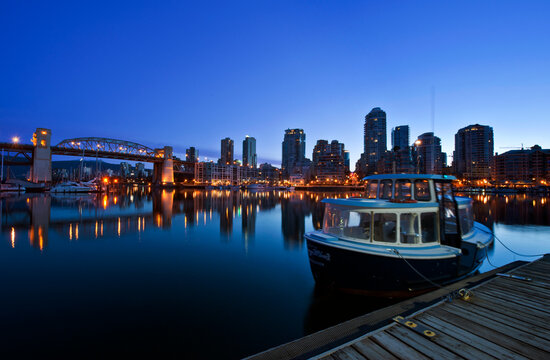 False Creek Ferry and waterfront at Dawn, on flat calm water, low light