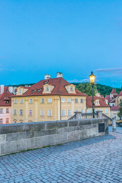 Charles Bridge at Dawn, an ancient cobbled bridge over the river.