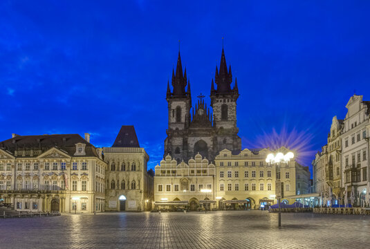 Prague city Old Town Square at night, the Gothic Church of Our Lady before T&yacute;n, silhouette of the twin towers, and outdoor restaurants.