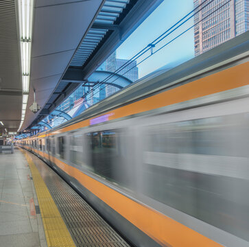 Marunouchi, Tokyo Station, Commuter Train moving through a station.