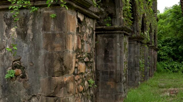 Vasai, Maharashtra, India - July 30, 2026: Ancient Stone Fort Exterior Surrounded by Monsoon Greenery. 