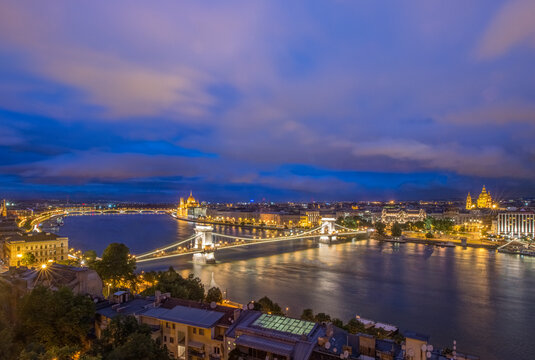 Elevated view across the River Danube and the city of Budapest, Houses of Parliament and the Chain Bridge at twilight.
