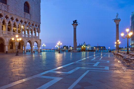 View from the Piazza San Marco to the Doge's palace and the waterfront in Venice and a distant island at dusk, lights and reflections 