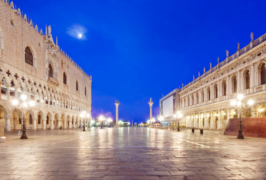 St. Mark's Square (Piazza San Marco) at Dawn, lights reflecting on the wet paving, the Doge's Palace, high tide, high water or Acqua alta.