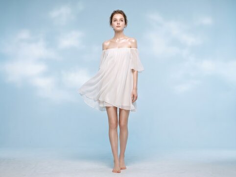 Woman in flowing white dress ethereal - studio fashion portrait