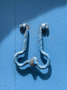 Door knocker on a blue door.