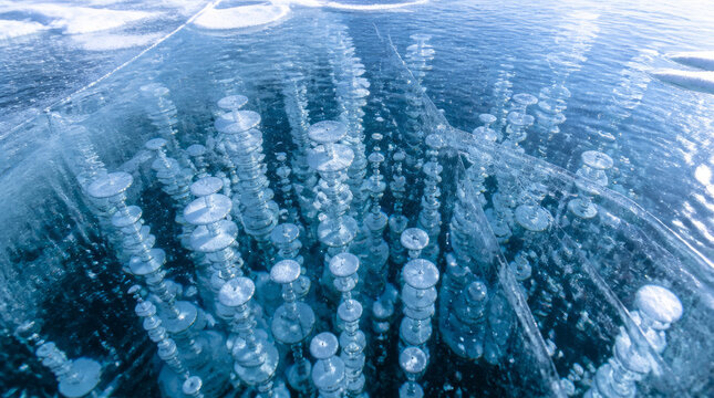 Frozen bubbles trapped beneath transparent winter lake ice create mesmerizing scene of nature beauty and wonder