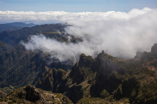 View from Pico de Areeiro, the mountain peak in the middle of the island of the surrounding peaks and valleys, mist and cloud rolling in.