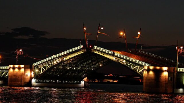 Illuminated Palace Drawbridge opening at night, engineering and urban architecture in cityscape. Dvortsovy bridge - symbol of St. Petersburg, Russia. Travel agencies, guides, tour operators footage