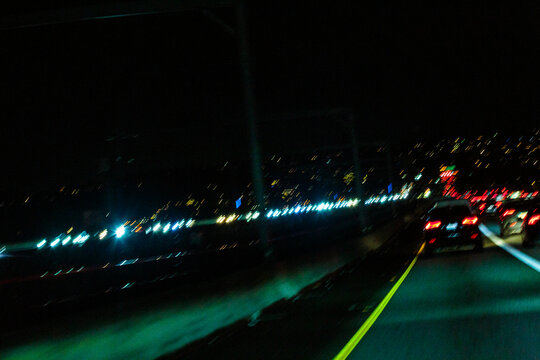 Wet roadway on Interstate 90 in Seattle at night.