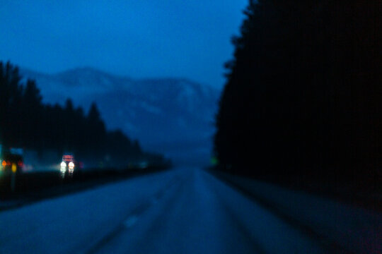Limited visibility on the wet surface of Interstate 90 through the Cascade Mountains