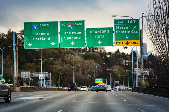 Interestate 90 in Downtown Seattle, an overhead gantry with road signs, lane direction and distance information.