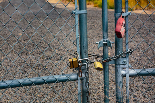 Combination locks on chain link fence, a close up.