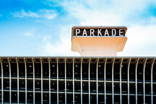 A multi storey car park building with a sign, the exterior, low angle view.