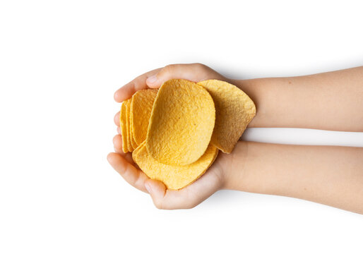 Top view of children's hands holding chips