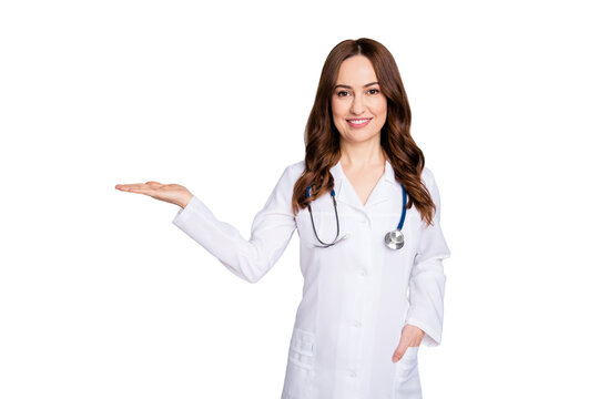 Photo of beautiful family doc lady assistant virology clinic hold open palm empty space show novelty product advising disinfection wear lab coat stethoscope isolated grey color background