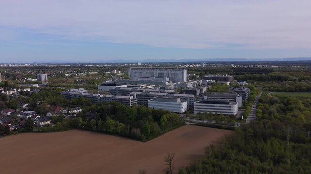 Wide aerial landscape with LMU University Hospital Munich in suburban area. Large hospital complex, modern healthcare facility and academic medical campus in Germany.