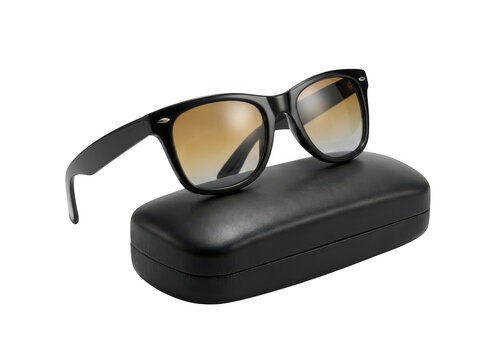 Black sunglasses with gradient lenses resting on a black leather case isolated on transparent background