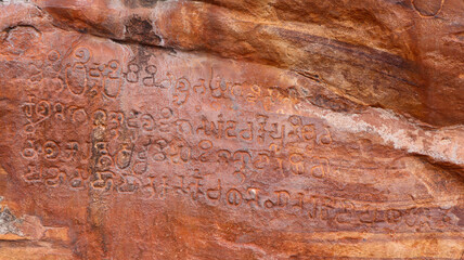 Naklejka premium Ancient old Kannada Scriptures on the Badami Caves, Karnataka, India.