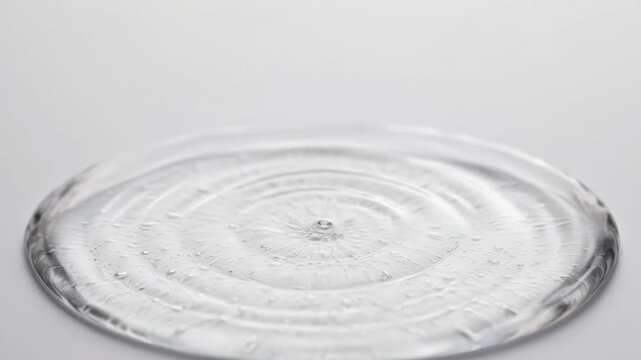 Mesmerizing water droplet impact creating hypnotic waves in slow motion