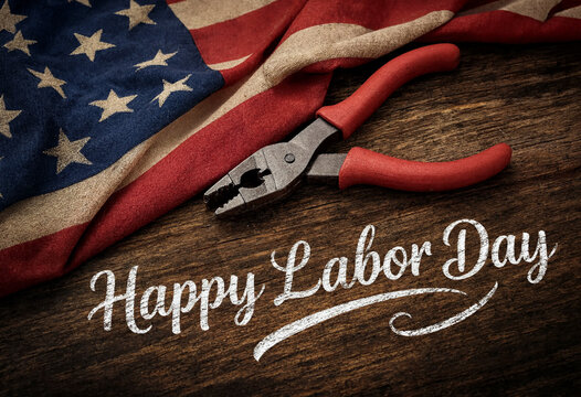 Happy labor day celebration with american flag and pliers on wooden table