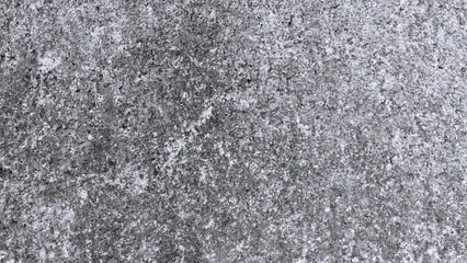 Fototapeta premium Monochrome rocky ground texture with scattered stones, soil and natural earth details, black and white background for outdoor and geological themes.