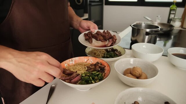 Professional cook preparing a traditional Japanese ramen dish with pork, noodles, and vegetables