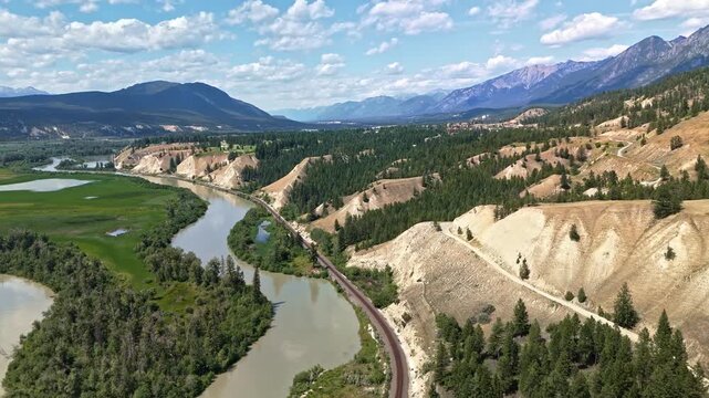Aerial view of winding river valleys and towering rocky mountains near Radium Hot Springs, British Columbia, Canada. 