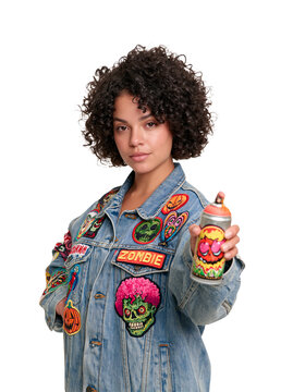 Young Woman with Curly Hair in Denim Jacket Holding Spray Paint Can isolated on transparent or white background, png