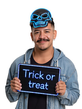 Smiling Man with Blue Glowing Skull Mask on Head Holding Trick or Treat Sign isolated on transparent or white background, png