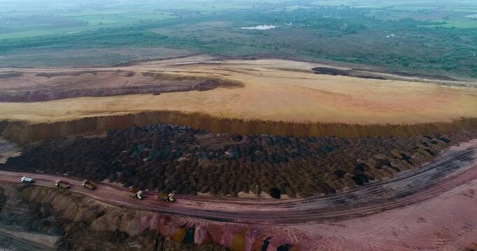 Aerial Drone View of Terraced Open Pit Coal Mine with Heavy Machinery in India

