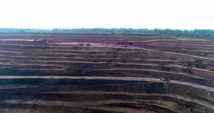Aerial Drone View of Terraced Open Pit Coal Mine with Heavy Machinery in India
