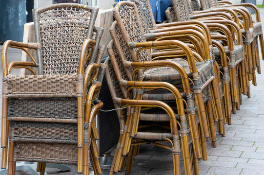Stacked Rattan Chairs Outside Cafe Terrace