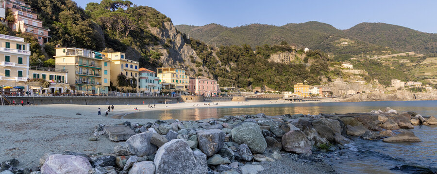 Monterosso al Mare at night on the Italian coast with illuminated seaside buildings and reflections