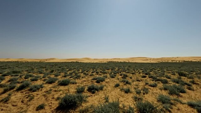 SUV driving off-road through desert landscape with sand dunes in background