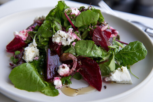 Salad greens with pickled beetroot, goat cheese