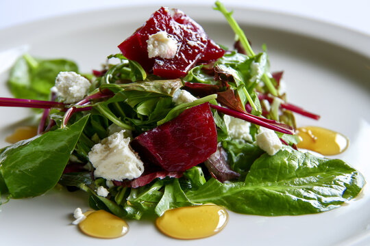 Salad greens with pickled beetroot, goat cheese, honey