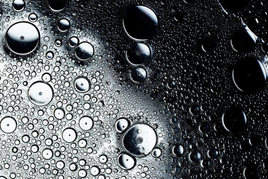 Oil and water droplets creating abstract monochrome texture