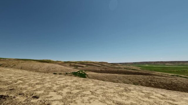 SUV driving off-road across rugged terrain with visible landscape changes