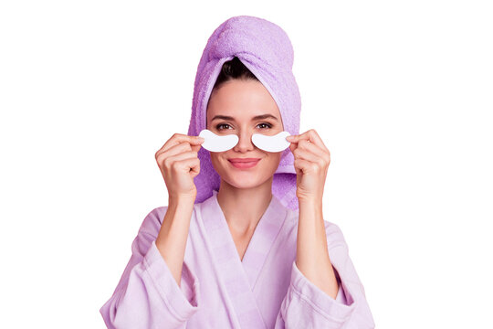 Close-up portrait of nice feminine girl wearing turban putting natural patch under eye collagen treatment isolated on pink pastel color background