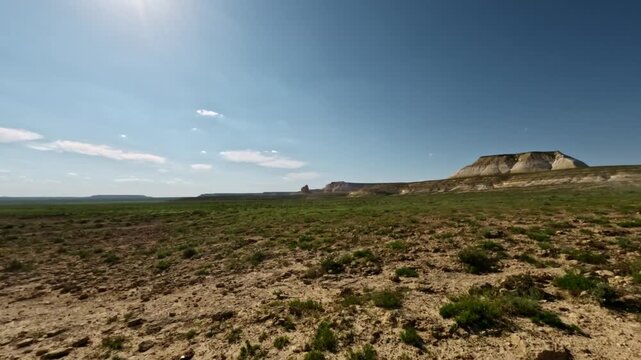 SUV driving off-road through rugged terrain with expansive landscape views