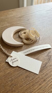 Simple Ceramic Crescent Moon with Clean Focus Tags on Wooden Surface, Low Attention Span Aid